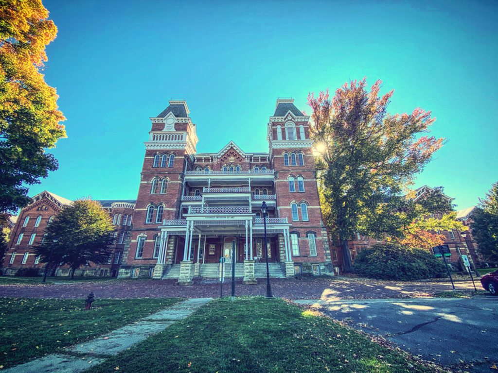 The Main Building of the Ridges Asylum with a bright blue sky above.