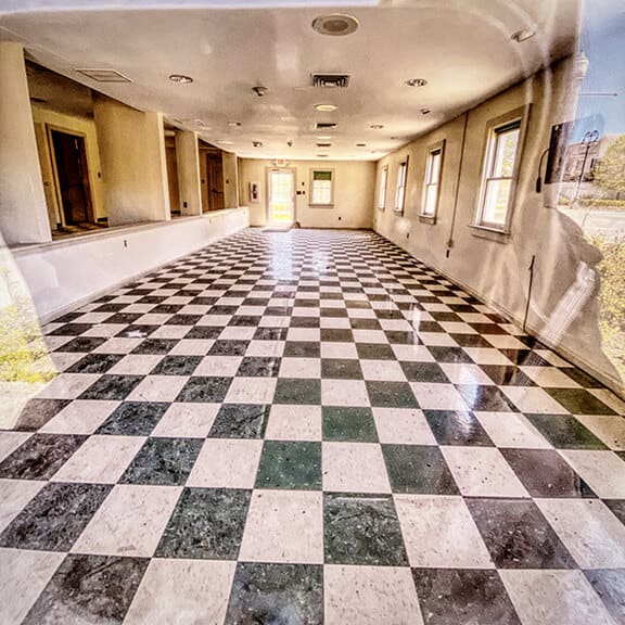 Abandoned shop with black and white checkered floor