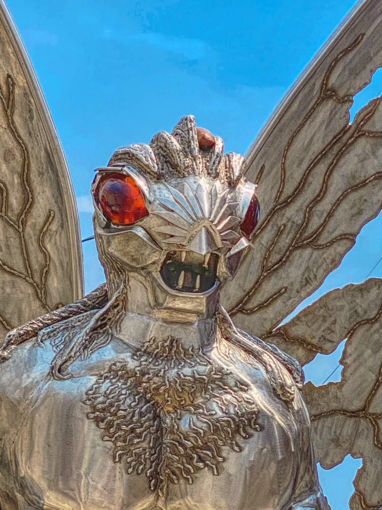The head and red eyes of the Mothman statue